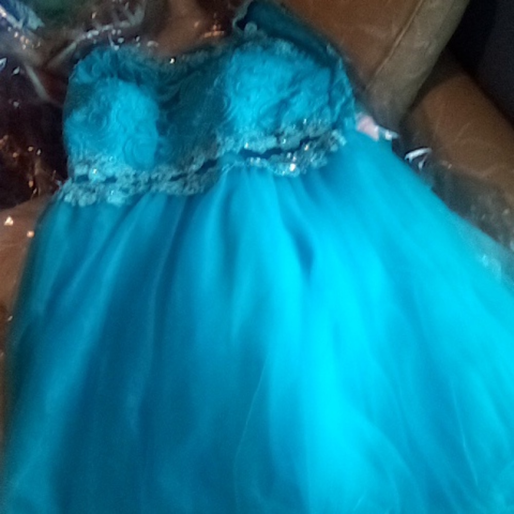 A blue dancing queen dancing  has one small spot on it shown in picture